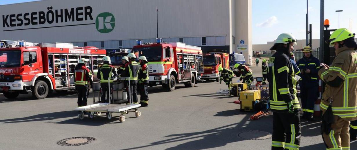 Großübung Dahlinghausen Kesseböhmer 2022 Feuerwehrfahrzeuge stehen vor einer Werkhalle.