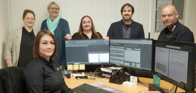 Gruppe von Personen im Büro vor PCs