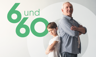 Zwei Personen stehen Rücken an Rücken, links daneben die Zahlen 6 und 60