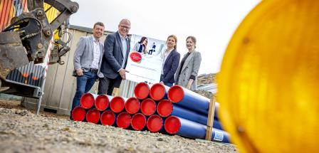 4 Personen stehen vor Baustelle