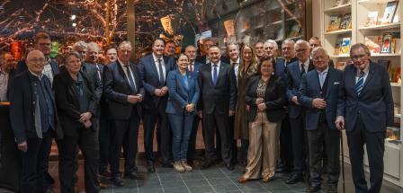 Eine Personengruppe steht in einem Foyer.