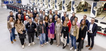 Personengruppe steht in einer Werkhalle