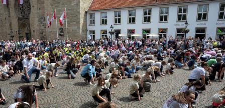 Menschenmenge auf einem Platz, historische Gebäude im Hintergrund
