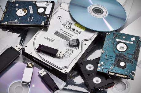 AWIGO Datenträger Festplatten und CD-ROM liegen auf einem Stapel.