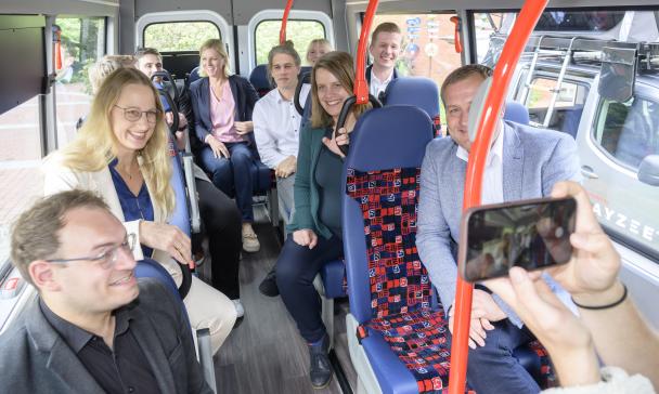 Eine Personengruppe sitzt in einem Bus.