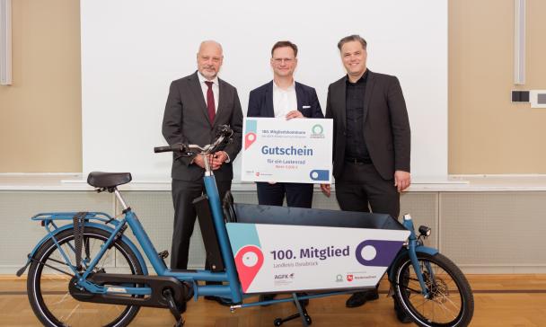 3 Personen vor Lastenrad