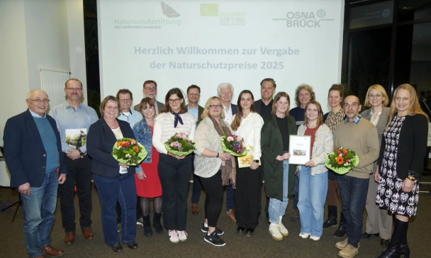 Personengruppe steht vor einer Projektionswand